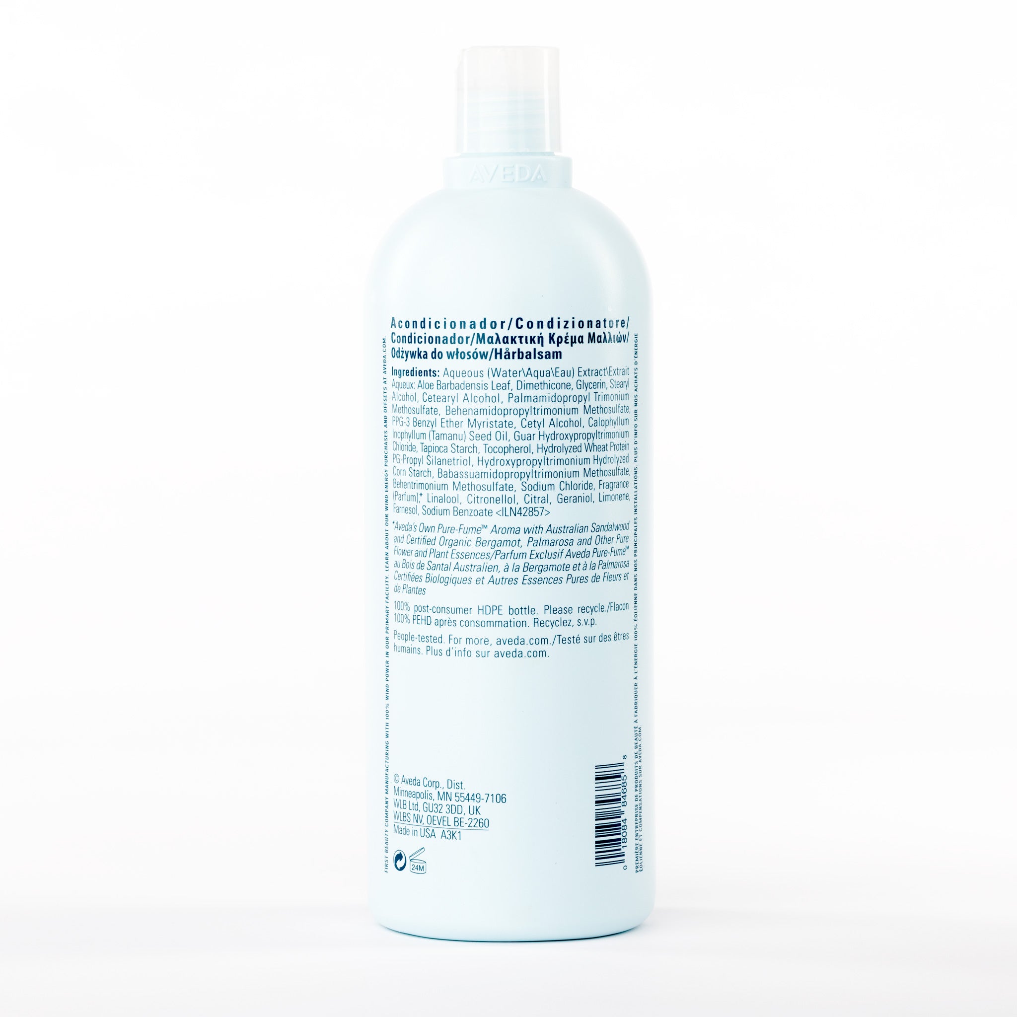 Back view of a bottle of Aveda Smooth Infusion conditioner with a label on a white background