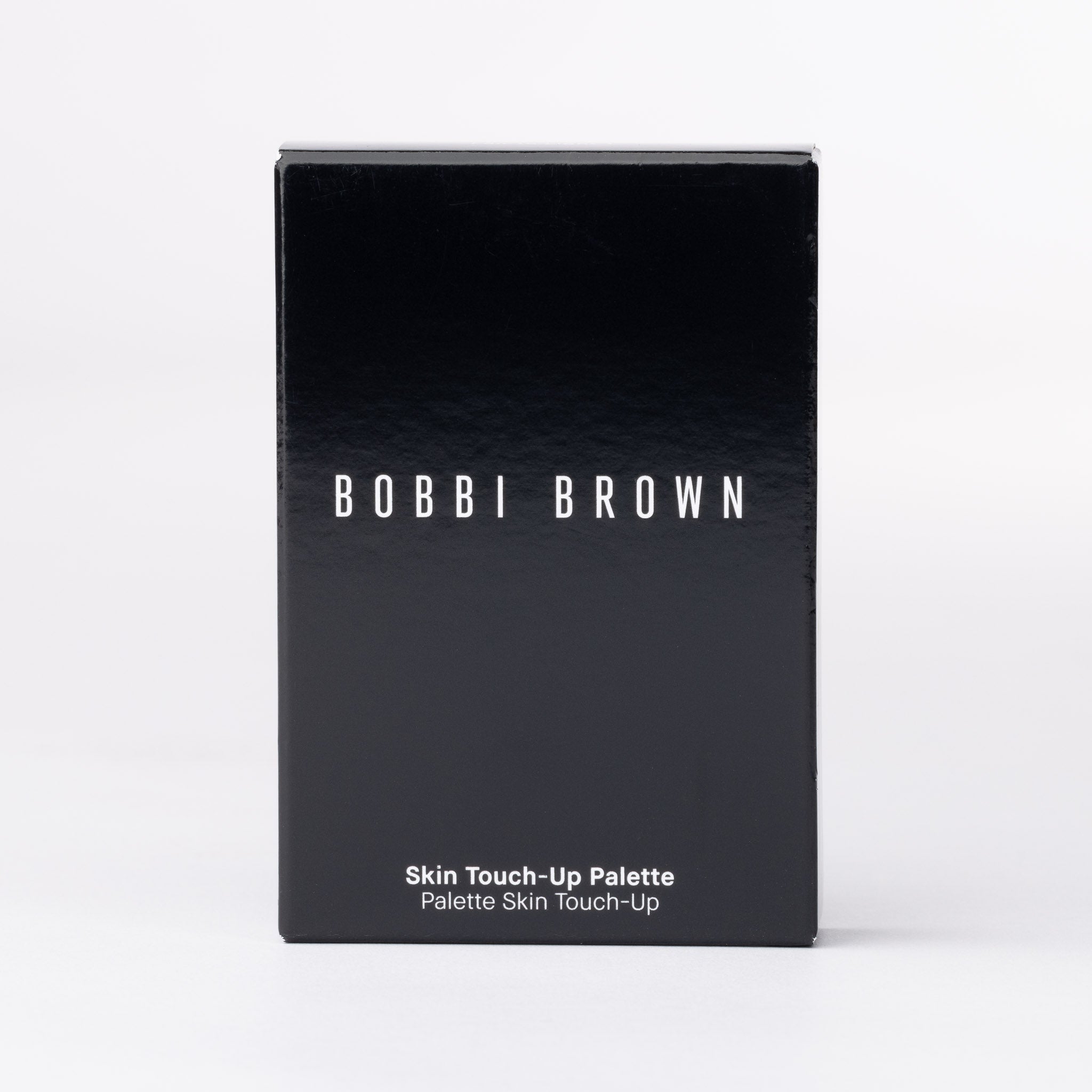 Bobbi Brown Skin Touch-Up Palette. Black, glossy box with crisp white text for luxury UK beauty.