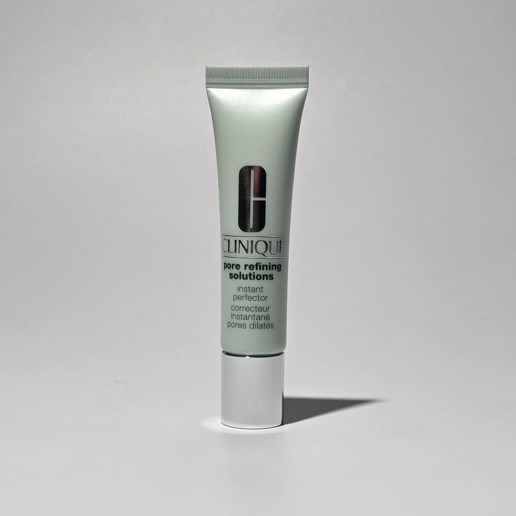 Clinique skincare tube on a gray background