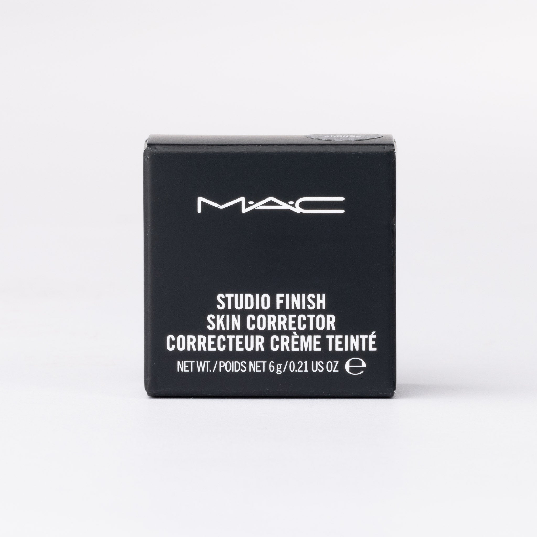 MAC Studio Finish Skin Corrector, Orange tinted cream in black box packaging.